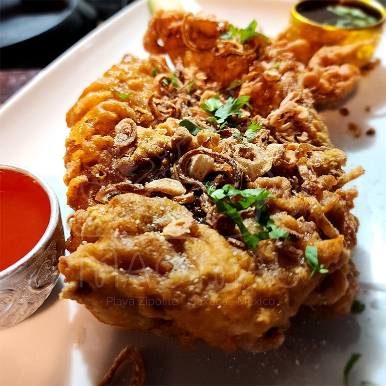 Gai Tod - Fried marinated boneless chicken thighs with crispy fried shallots, sweet chili spicy & jaew sauces. Served with pickled cucumber