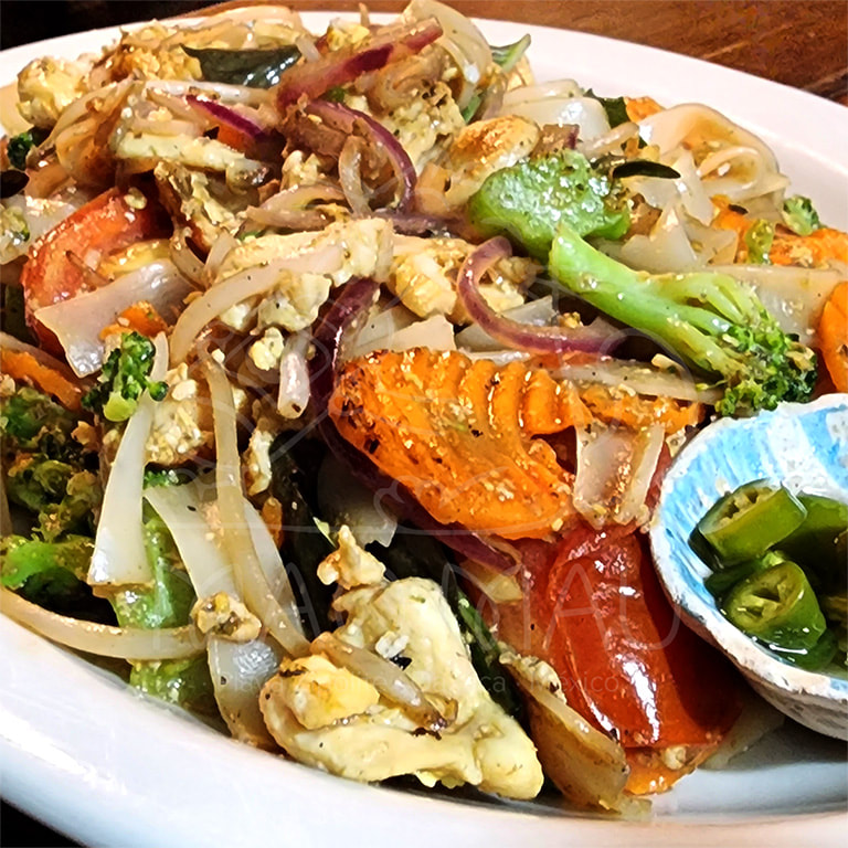 Pad Kee Mau** - Spicy sautéed rice noodles, egg, bean sprouts, onion, broccoli, tomato, baby corn & basil: with vegetables, fried tofu, chicken, sliced beef, or shrimp