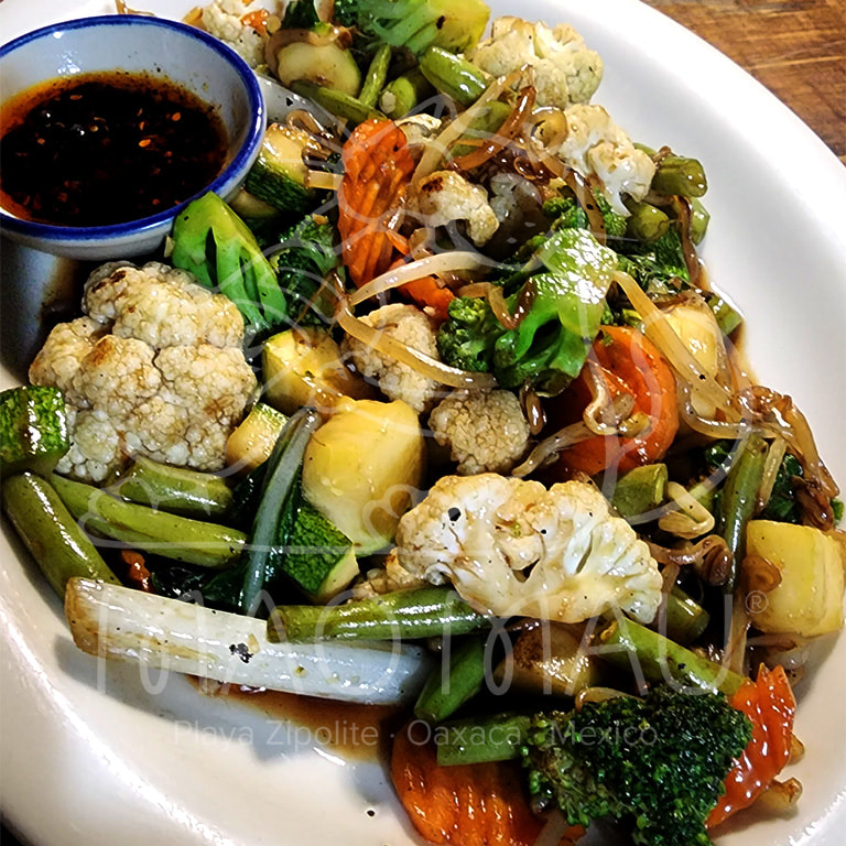 Pad Puk - Mixed vegetables and locally grown Asian greens (when available) sautéed with soy, garlic & sesame oil. Available traditional or vegan (v)